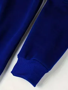Detailed view of deep blue velvet sweatshirt sleeve showing high-quality ribbed elastic cuff