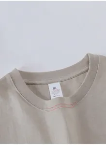 Close-up of reinforced double-needle stitched neckline on a 230g men's T-shirt