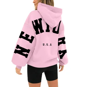 Back view of a pink oversized fleece hoodie with New York USA print.