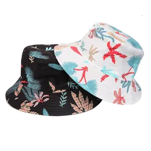 Detailed view of two tropical floral print bucket hats in black and white cotton.
