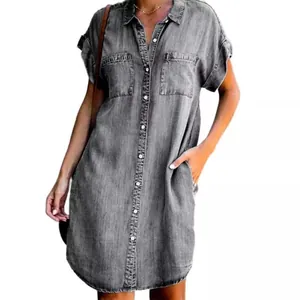 Close-up view of a gray short sleeve denim shirt dress with button-down front and pockets
