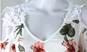 Vista detallada de vestido floral para mujer con cuello en V y hombros de encaje blanco