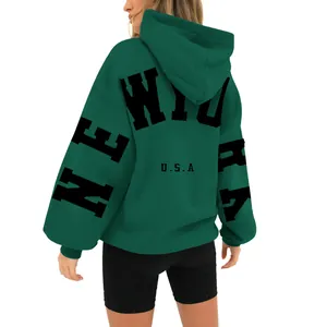 Detailed back view of dark green oversized hoodie featuring black New York print