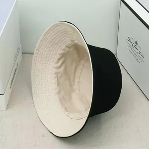 Detailed interior view of a black and beige double-sided cotton bucket hat