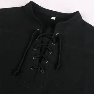Detail of black medieval Renaissance shirt with lace-up bandage neckline and silver eyelets.