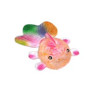 Macro detail of a colorful goldfish squeeze toy with a translucent maltose texture.