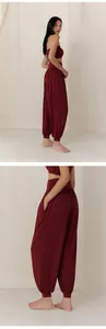 Detail view of breathable burgundy harem yoga pants for dance and Pilates practice.