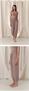 Detailed side profile showing high-waisted loose harem yoga pants in breathable mauve fabric
