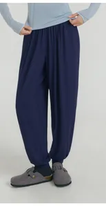 Detail of loose navy blue harem yoga pants with cinched cuffs for athletic women