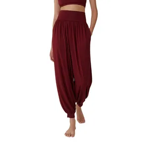 Women's burgundy loose-fit high-waisted harem yoga pants for dance and Pilates.