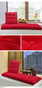 Detail view of thick red corduroy seat cushion showing corn-grain texture and cozy home setting
