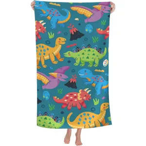 Detail of quick-dry microfiber beach towel with vibrant cartoon dinosaur pattern