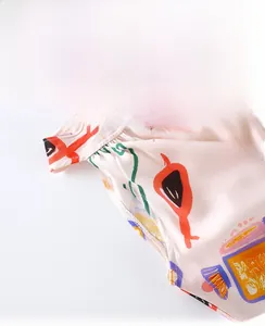Close-up detail of girls' artistic print sleeveless summer dress stitching.