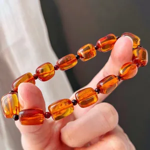 Macro view of translucent amber resin bracelet with Maillard style beads and spacers