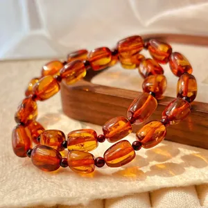 Close-up of translucent amber beaded bracelets with warm Maillard aesthetic tones