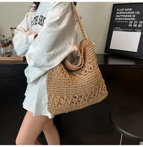 Casual straw woven tote bag with colorful strap shown on shoulder, summer vacation style.