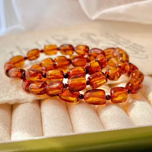 Macro detail of natural honey amber beaded bracelets in retro Maillard style