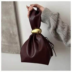 Niche retro burgundy pleated bucket bag with a unique gold metallic hardware detail.