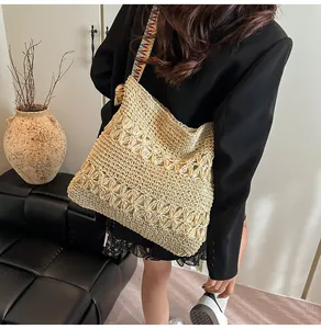 Large bohemian woven straw tote bag featuring a colorful wide shoulder strap design