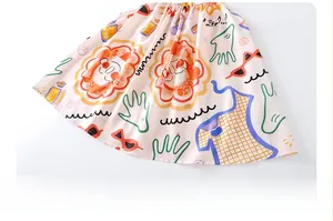 Close-up detail of girls' sleeveless summer dress featuring colorful artistic prints