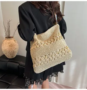 Large handmade straw woven tote bag with intricate floral patterns and colorful strap