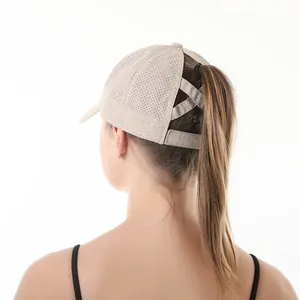 Detailed back view of breathable ponytail baseball cap with criss-cross straps in beige
