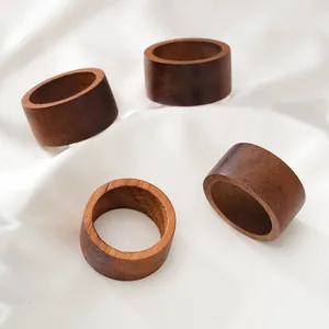 Detailed view of minimalist wooden napkin rings with natural wood grain texture