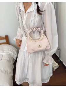 Cute light pink pleated handbag featuring a bear patch and silver chain strap detail