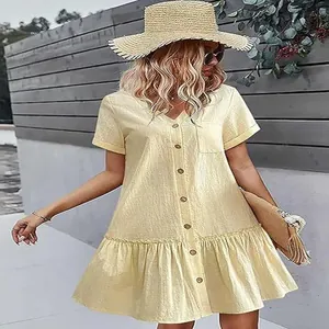 Summer yellow short sleeve button down dress with loose ruffled hem and front pocket