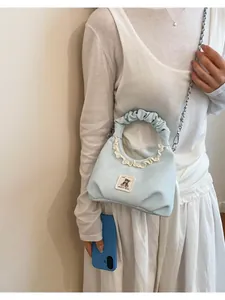 Charming light blue pleated handbag featuring delicate lace trim and a cute bear patch.