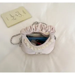 Interior view of pink pleated handbag with lace trim showing storage capacity