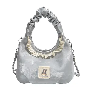 Silver ruffled handbag with delicate lace trim and cute bear patch for daily wear