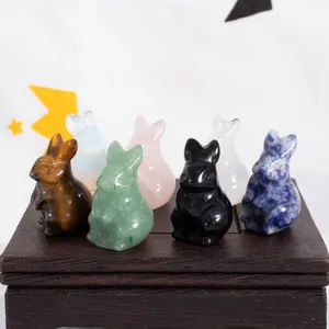 Detailed macro view of six colorful natural crystal rabbit figurines on a wooden base