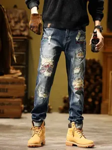 Detailed view of men's slim-fit retro ripped denim jeans with American style patches