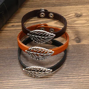 Vintage leather bracelets with metallic leaf charms in dark brown, tan and black.