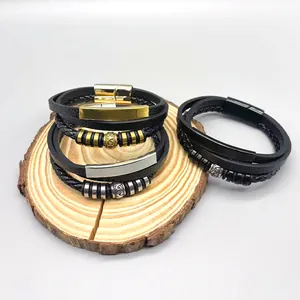 Detail shot of multi-layer leather braided bracelets with magnetic clasps on wood.