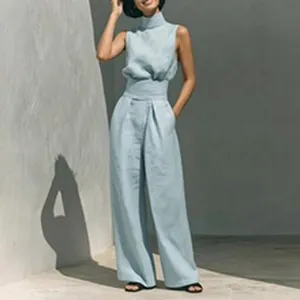 Detail view of a light blue high-neck sleeveless jumpsuit with wide-leg pants.