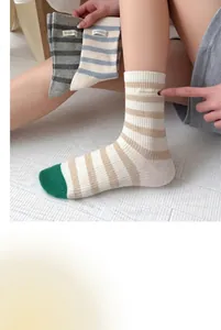 Close-up view of striped combed cotton socks in macaron colors for fashionable women