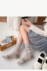 Cute cat pattern cotton mid-calf socks for women shown in a cozy home lifestyle setting