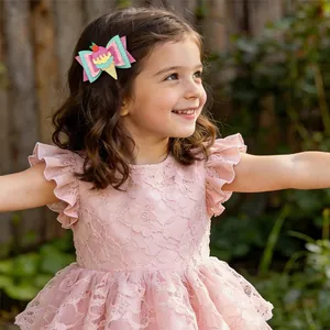 Adorable glitter ice cream cone hair clip accessory worn by a young girl in a pink dress