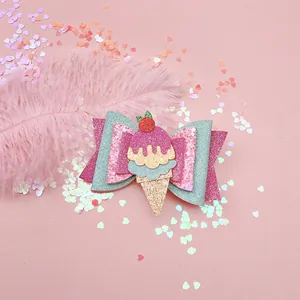 Close-up of a glittery ice cream cone hair clip for girls with a pink bow.