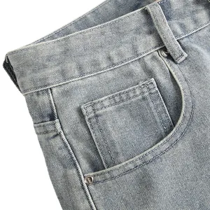 Detail view of light blue denim shorts for men with pocket stitching and rivets