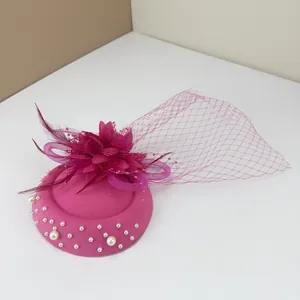 Elegant fuchsia pillbox fascinator hat with flower feathers mesh veil and pearl accents