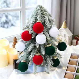 Set of flocked velvet Christmas balls in red, white, and green for tree decoration.
