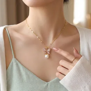 Elegant French style gold butterfly necklace featuring pavé crystals and a white pearl drop