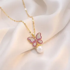 Elegant French-style butterfly necklace with pink zircons and pearl drop on gold chain