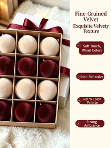 Close-up detail showing the fine flocked texture of cream and burgundy Christmas balls