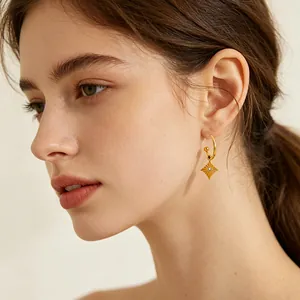 Minimalist stainless steel 18k gold plated starburst hoop earrings worn by model