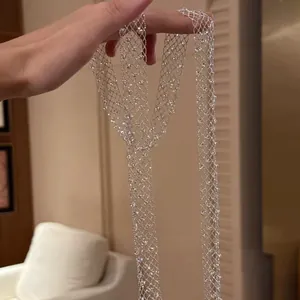 Close-up detail of shimmering silver hollow mesh necklace with clear glass beads