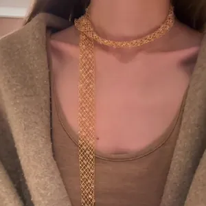 Detailed view of an elegant golden hollow mesh necklace for sophisticated layering.